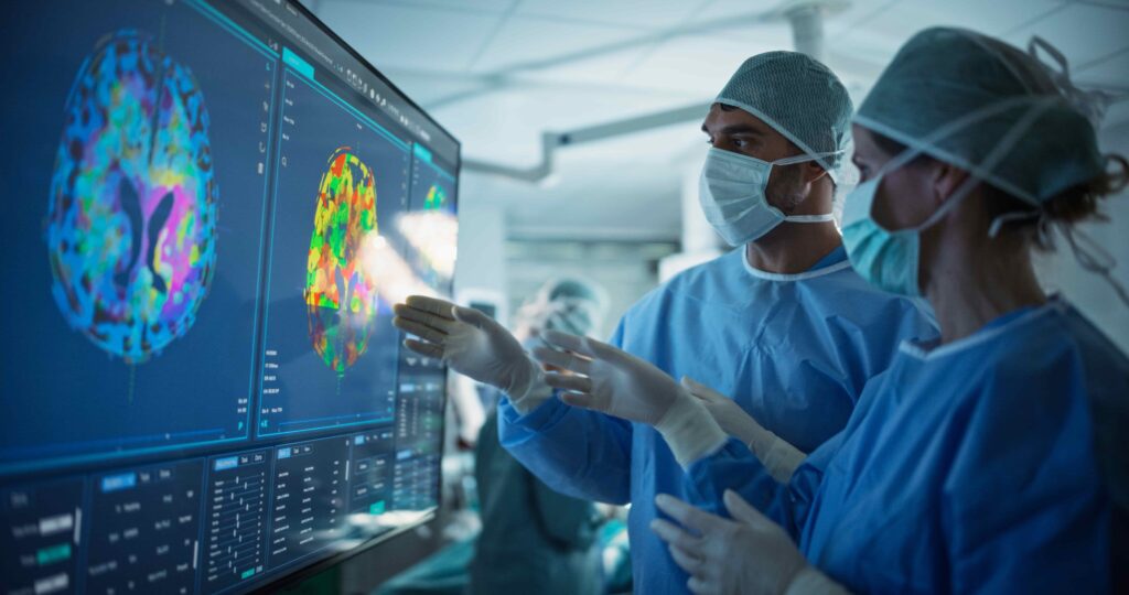 Surgeons analyzing advanced brain imaging scans on digital screen in operating room. Surgeons analyzing advanced brain imaging scans on digital screen in operating room.