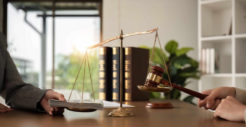 Scales of justice weighing cash against a judge&rsquo;s gavel, symbolizing legal corruption, bribery, or unethical legal practices